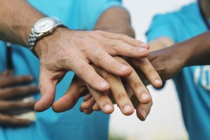 diverse hands stacked in agreement